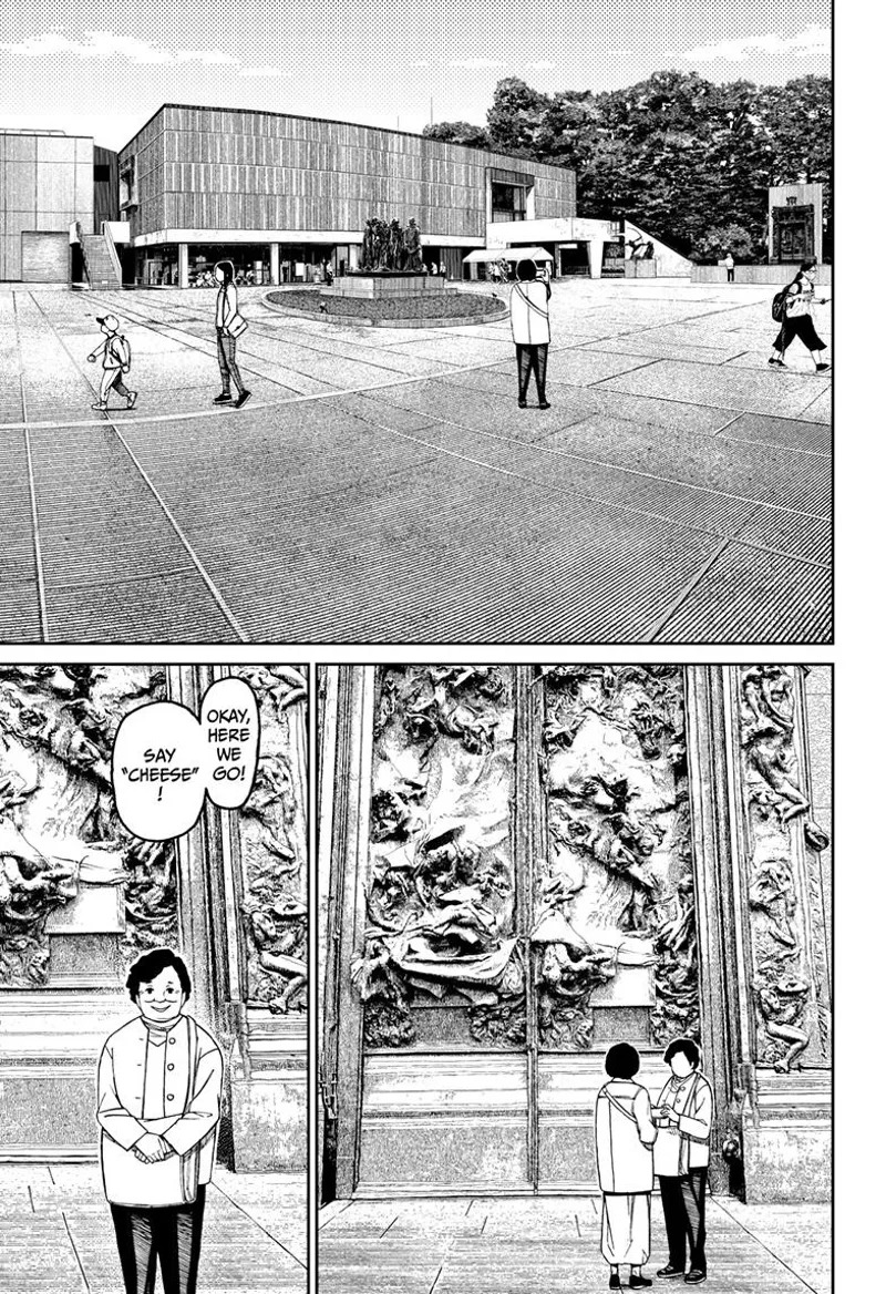 A huge park is in front of a museum, and inside, a woman stands before a huge door with weird sculptures.