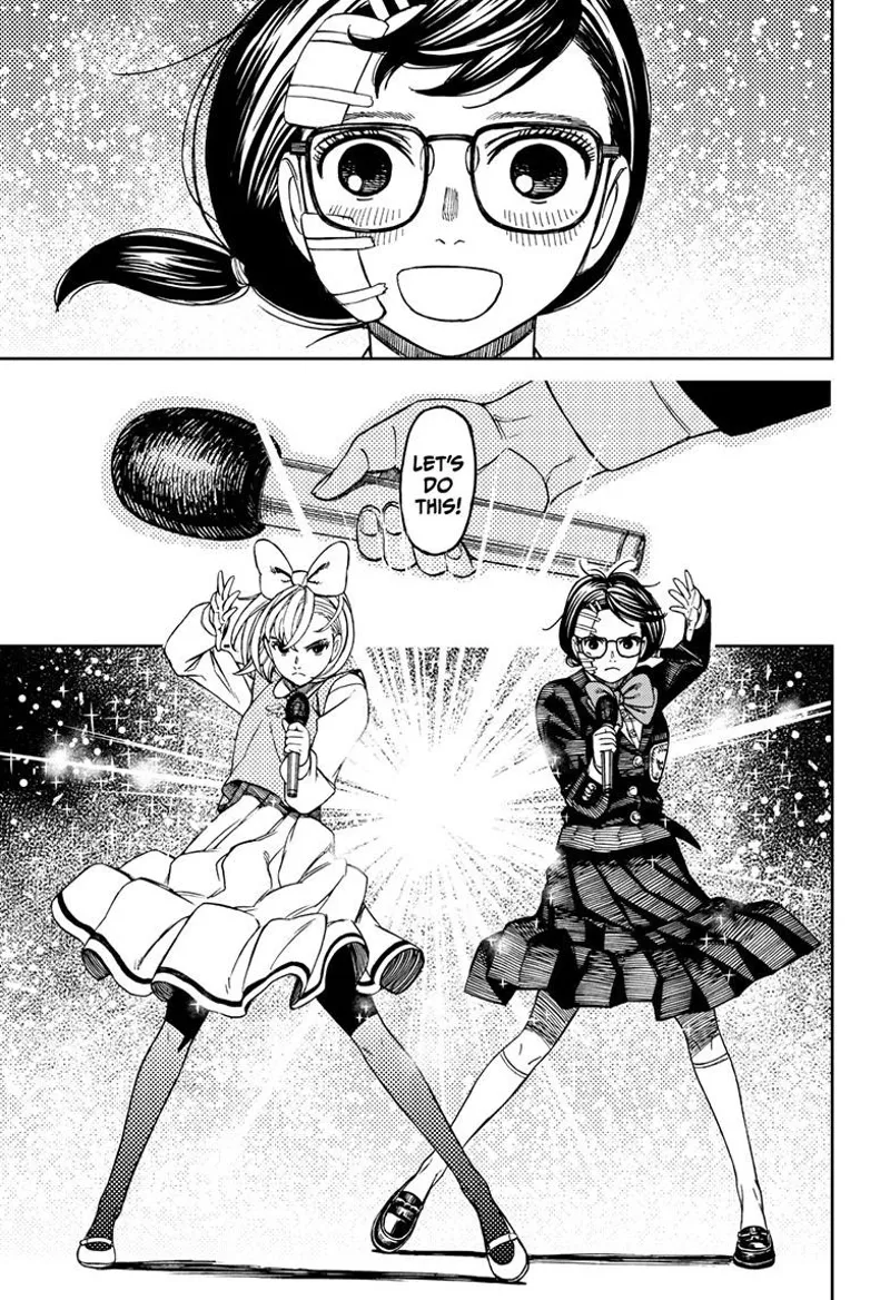 Rin and Mai hold microphones each. A bright light shines behind them.