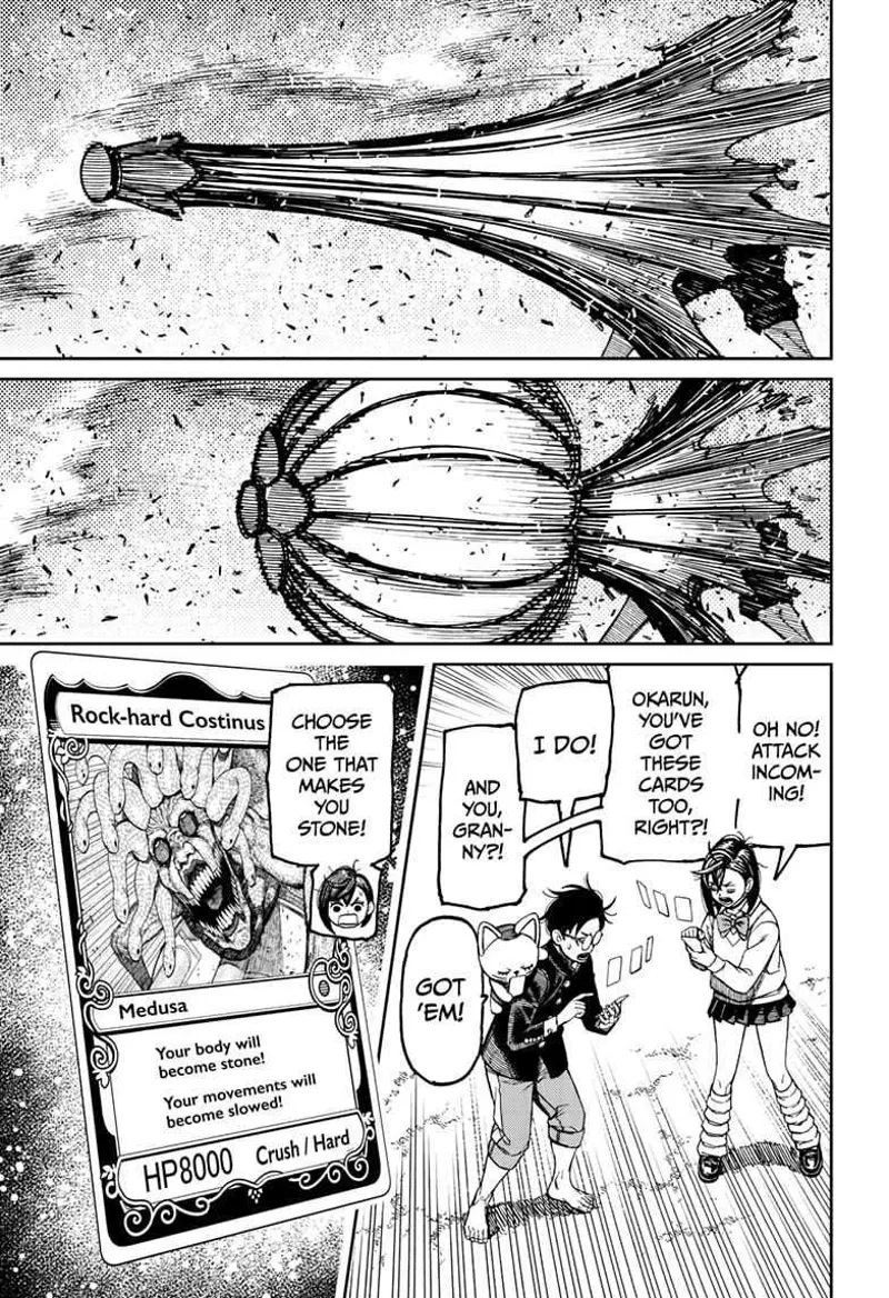Cursed Zuma closes his umbrella and prepares to fire it. Momo, Okarun, and Turbo Granny activate the stone snake card.