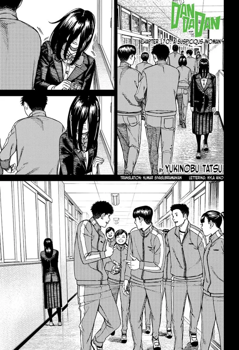 A suspicious student with long black hair walks along the side of the hallway as she passes through male happy students.