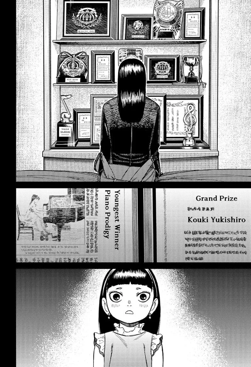 The student sits on the bed facing various awards from her sister, who is a piano prodigy. She recalls being a child.