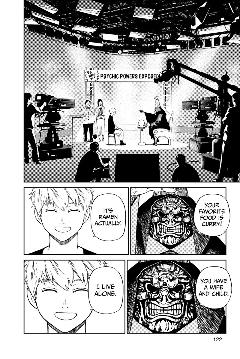 The two are on a set with cameras and a production crew for the program Psychic Powers Exposed. The masked man is psychic.