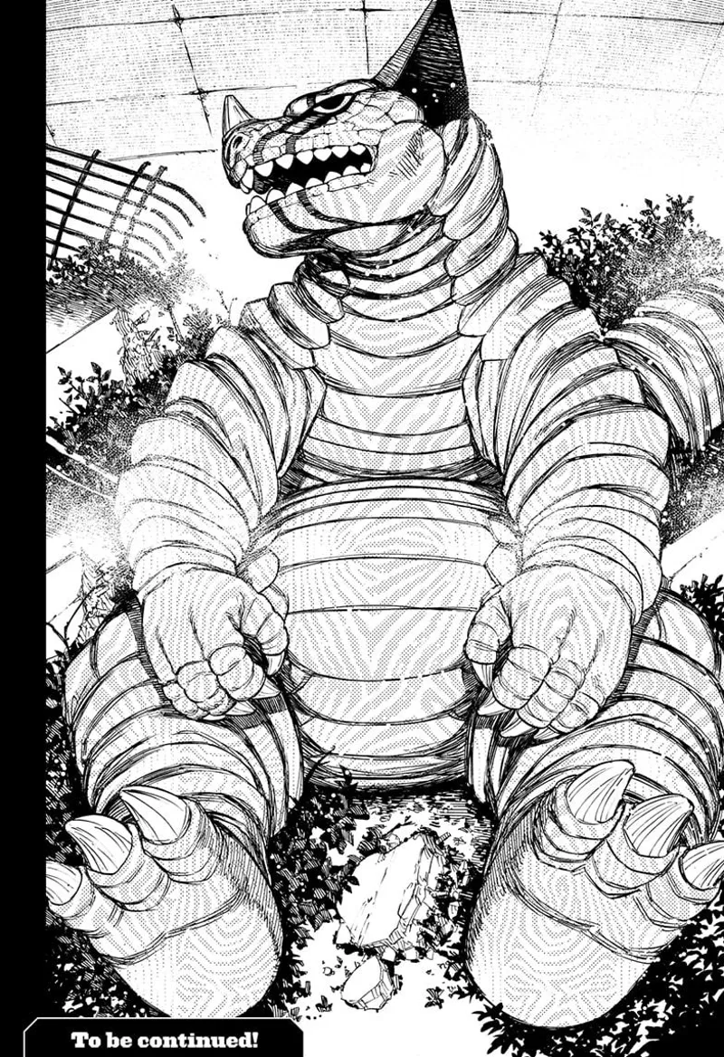 A creature that looks like a kaiju dinosaur is seen lying in the bushes with weird skin.